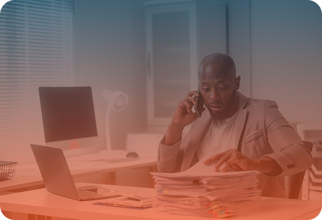 Man working on many documents seems tired